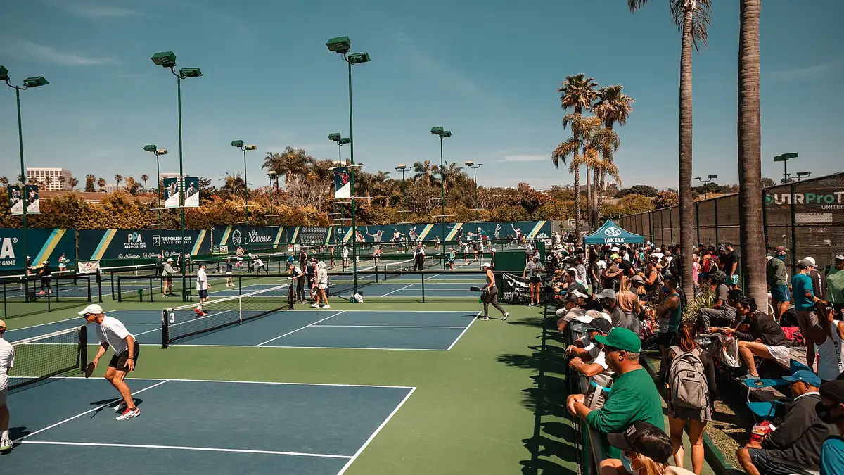 Doubles pickleball being played on outdoor courts