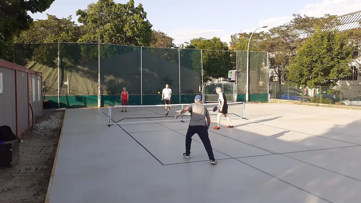 Pickleball players practicing on an outdoor court