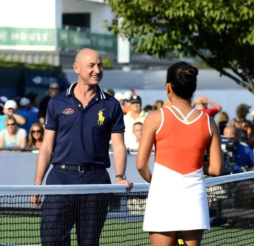 Chair umpire talking with a player on court